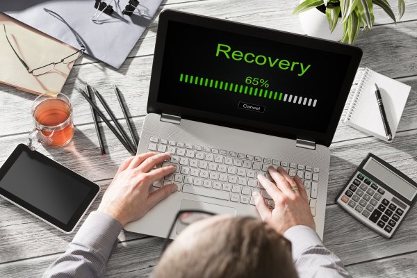 man on laptop recovery bar on screen online backup